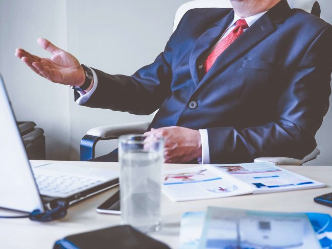 picture of a business man in a suit at a desk by protect commercial