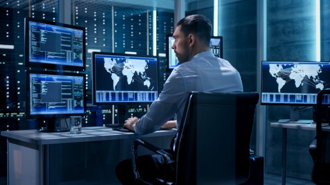 picture of a man at a desk coding cyber insurance for protect commercial